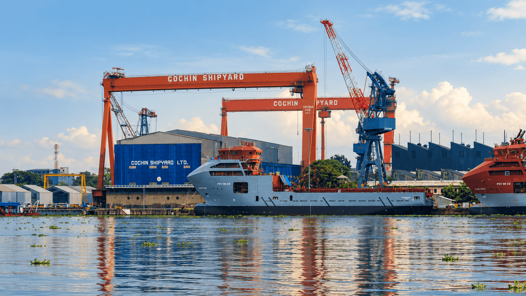 Cochin Shipyard gantry cranes and vessels seen from the water